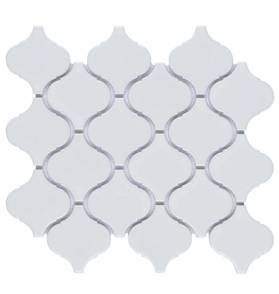 The Metro Lantern Mosaic Tile features a sheet of white arabesque-shaped geometric tiles in a repeating interlocking pattern with light gray grout lines.