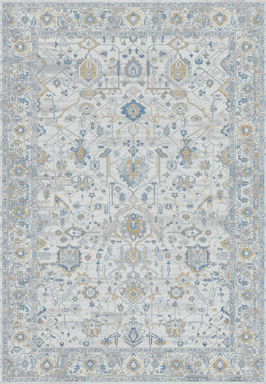 The Gold 1357 Area Rug showcases blue, gold, and beige motifs on a light background with a decorative border and symmetrical floral-geometric patterns. Its non-shedding design combines contemporary style with timeless elegance.