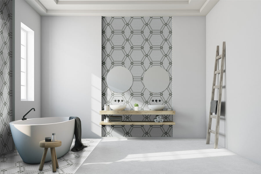 Modern bathroom with a freestanding tub, wooden stool, ladder towel rack, and double sink vanity with shelves. Above it are two round mirrors and an accent wall featuring Evolve Hexagon Flower Mosaic Tile. Light pours in from a large window.