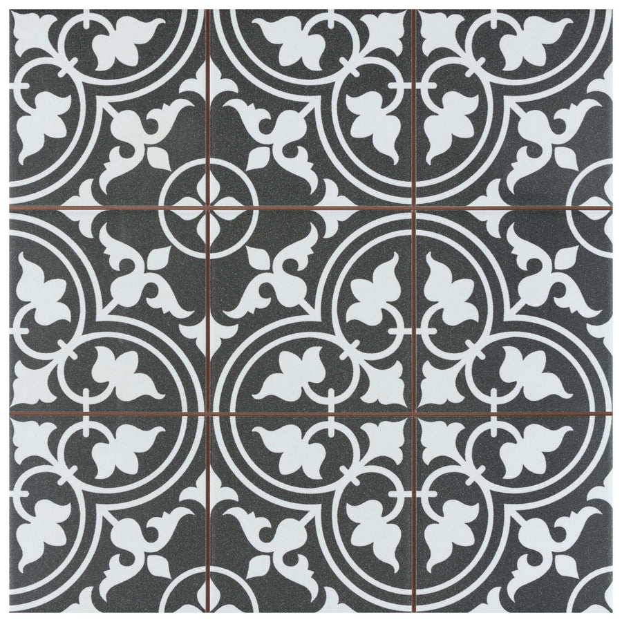 The Harmonia Classic 13x13 Patterned Tile features a black and white ceramic design with intricate floral and geometric motifs, curved lines, and symmetrical shapes for a timeless, vintage look on floors or walls.
