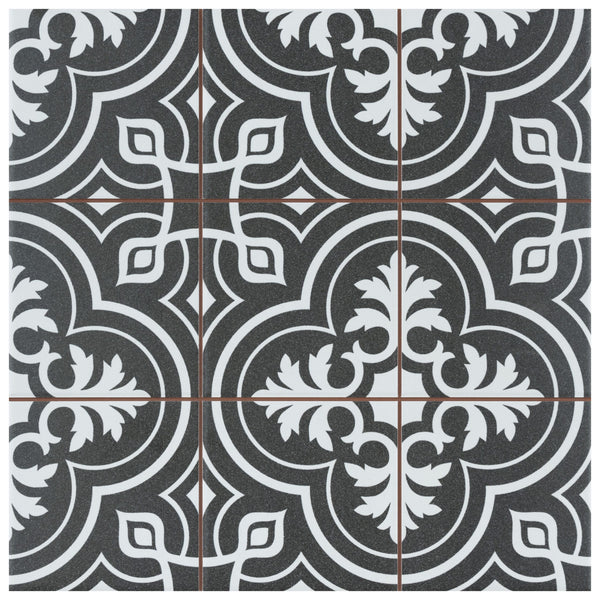 Four Harmonia Vintage 13x13 Patterned Tiles feature a black square base with an ornate white and gray symmetrical floral and geometric design, intersected by thin brown grout lines for a repeating decorative motif.
