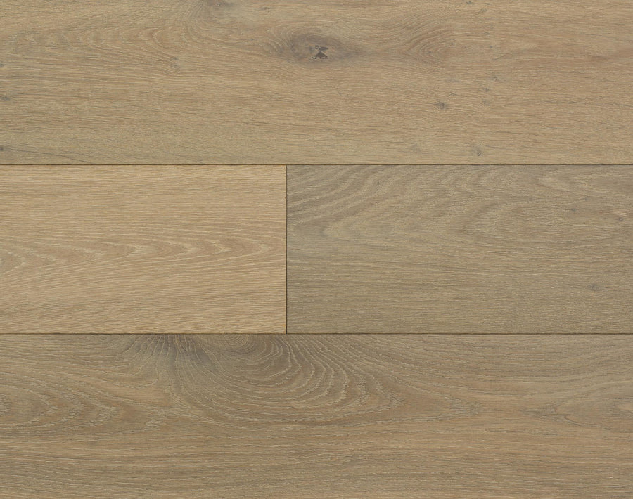Close-up of Huntington European Oak 7 1/2" Hardwood flooring, featuring light brown boards with visible wood grain, knots, and unique natural patterns. A reactive stain highlights the staggered layout and textured surface.