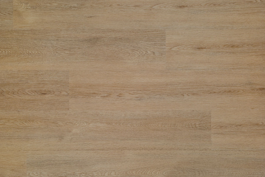 The Hydro Vinyl II 7" Vinyl Plank features a light brown wooden surface with natural grain patterns and color variations, offering the realistic look of hardwood in a waterproof SPC flooring.