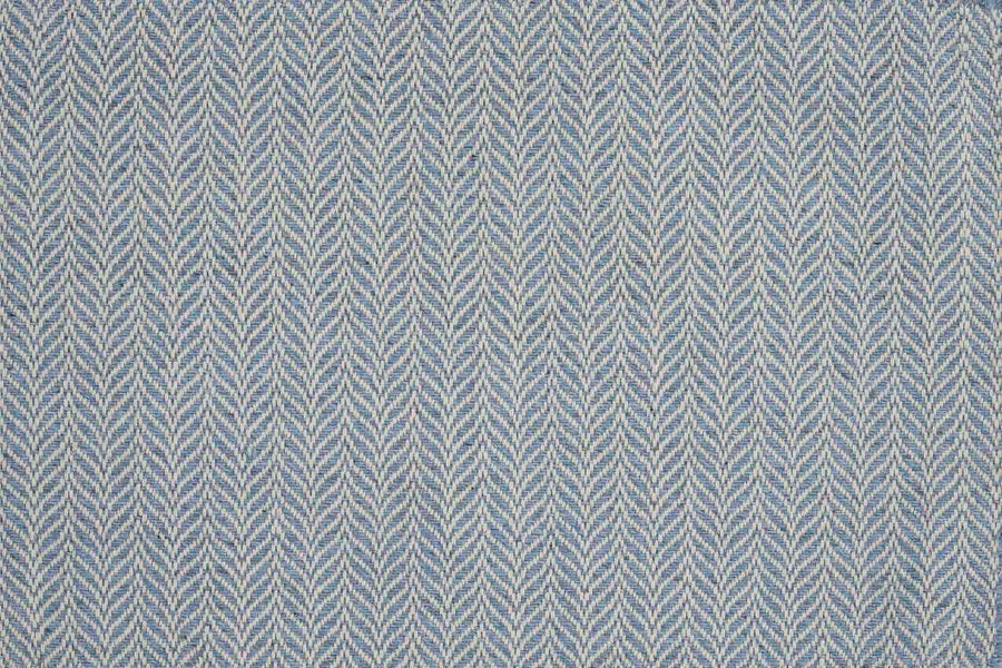 Close-up of Island Wave On Trend Carpet in light blue and white, featuring a repeating chevron (herringbone) pattern. The textured, woven look resembles a flatweave rug, with V-shaped lines running vertically across the surface.