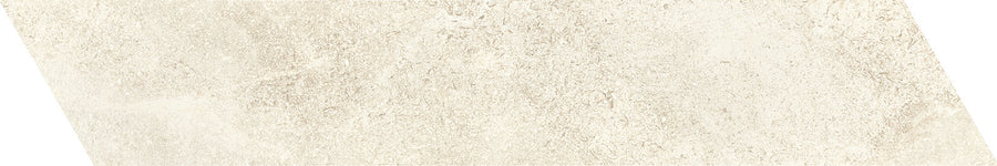 The Ibla 4x20 Chevron Porcelain Tile features a beige, textured, stone-like pattern with subtle mottling and irregularity—perfect for adding luxury and elegance to interior spaces with its distinctive chevron design.