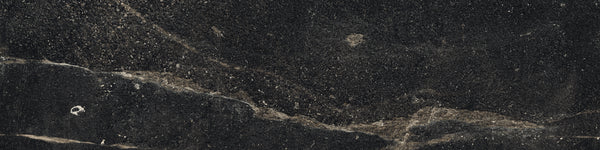 The Ibla 12x48 Large Format Porcelain Tile features a dark, textured surface with subtle beige and white streaks, creating a natural, rugged look—perfect for modern interiors seeking earthy elegance.
