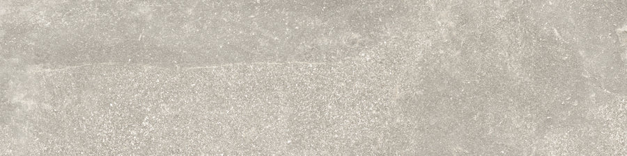 The Ibla 12x48 Large Format Porcelain Tile features a light grey, stone-like textured surface with subtle shade variations and a matte, slightly rough finish—perfect for modern interiors.