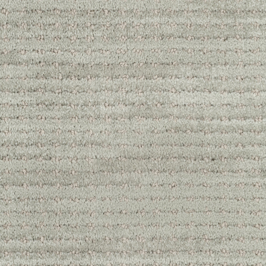 Close-up of Imagine Pet Friendly Carpet in light gray, featuring subtle horizontal lines and a soft, plush surface that highlights its handmade authenticity.