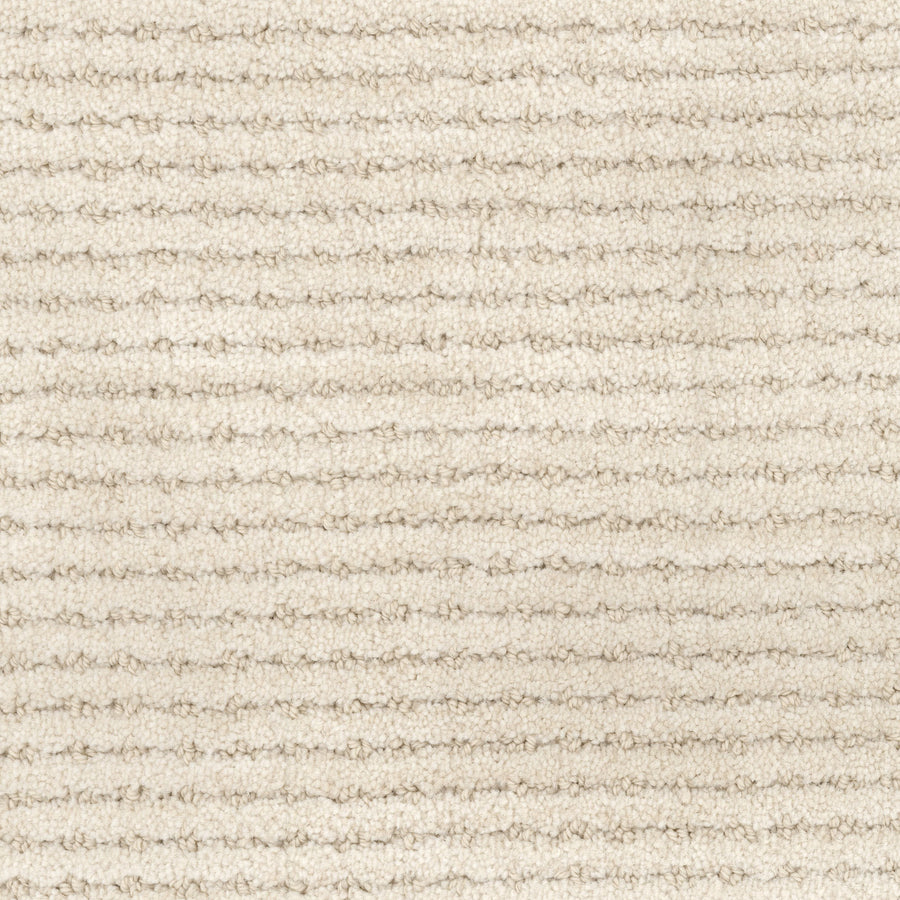 Close-up of Imagine Pet Friendly Carpet in beige, featuring a subtle horizontal ribbed pattern and plush, soft fibers with a uniform color that reflects handmade authenticity.