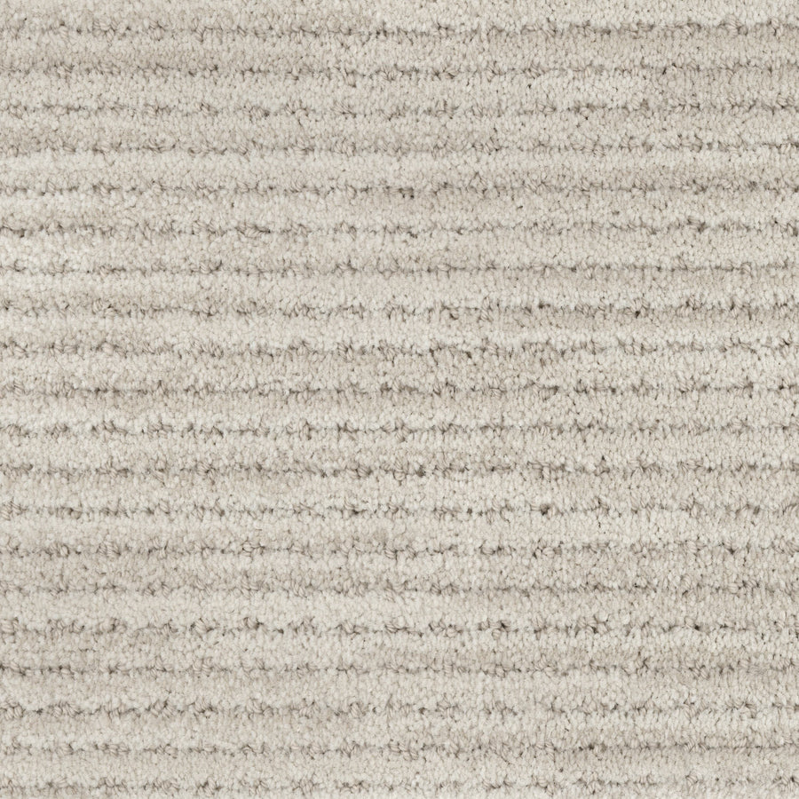 Close-up of Imagine Pet Friendly Carpet in beige, featuring soft, textured wool fibers and horizontal ridges. The consistent pattern creates a subtle striped look and adds a touch of handmade authenticity.