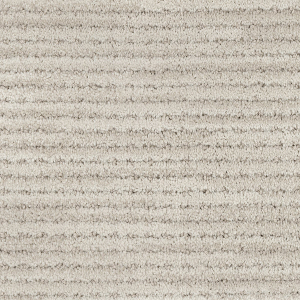 Close-up of Imagine Pet Friendly Carpet in beige, featuring soft, textured wool fibers and horizontal ridges. The consistent pattern creates a subtle striped look and adds a touch of handmade authenticity.