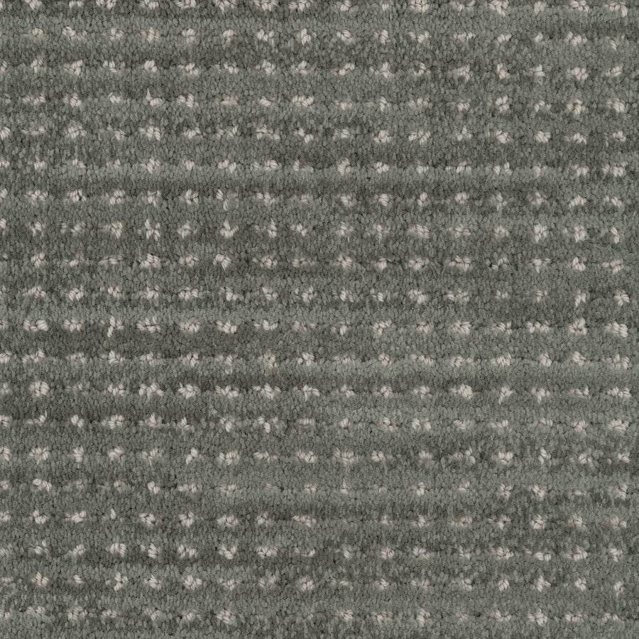 Close-up of Imagine Pet Friendly Carpet: textured gray wool with a soft, slightly fuzzy surface and a grid pattern of small, evenly spaced lighter dots and horizontal lines, showcasing handmade authenticity in every detail.