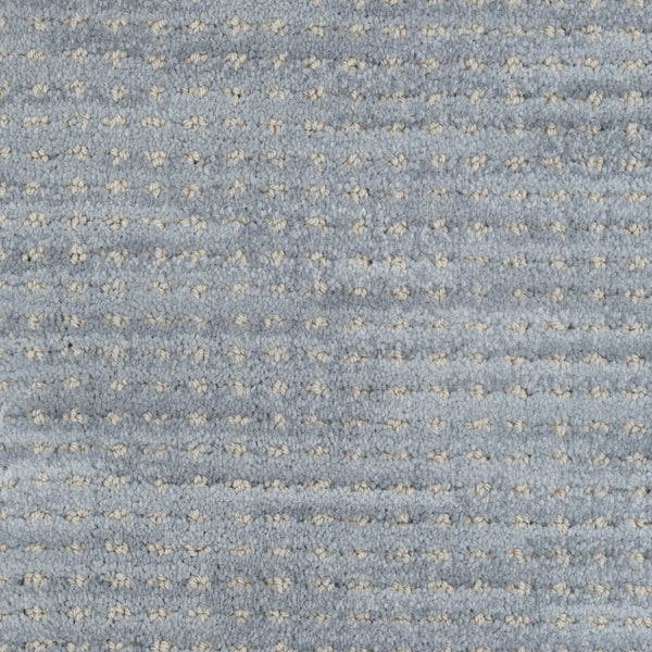 Close-up of Imagine Pet Friendly Carpet in textured blue wool, featuring a repeating pattern of small white dots. The soft, plush surface highlights its handmade appearance and quality craftsmanship.