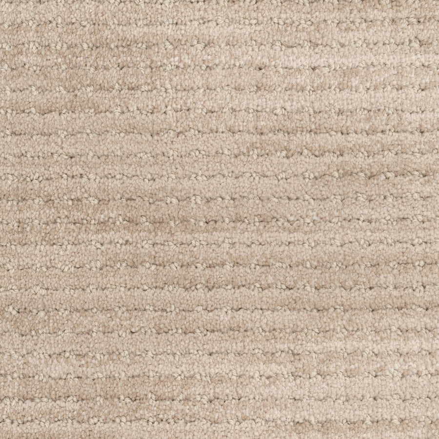 Close-up of Imagine Pet Friendly Carpet in beige, featuring a soft wool texture and horizontal striped pattern that highlights its handmade authenticity with subtle color variations.