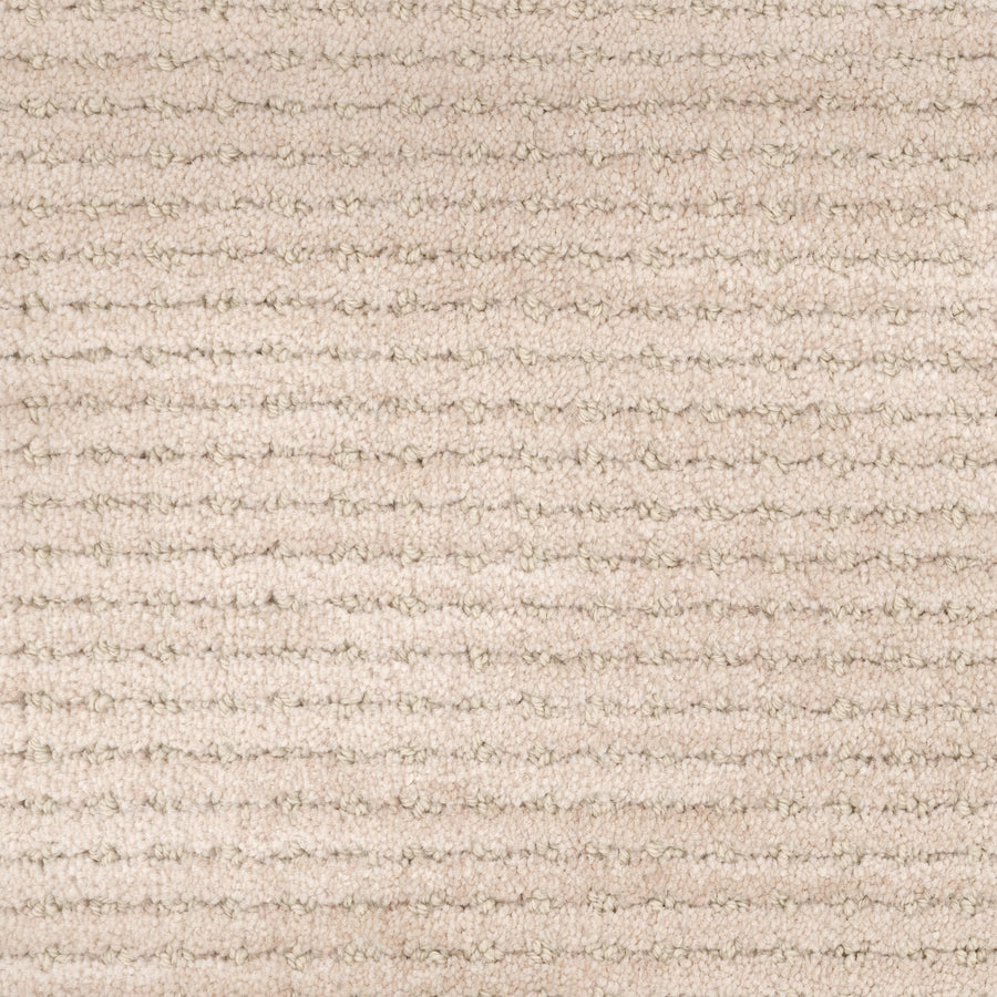 Close-up of the Imagine Pet Friendly Carpet in beige, featuring a uniform horizontal striped texture and soft, raised fibers. The neutral tone adds warmth and cozy appeal, while its handmade look enhances any space.