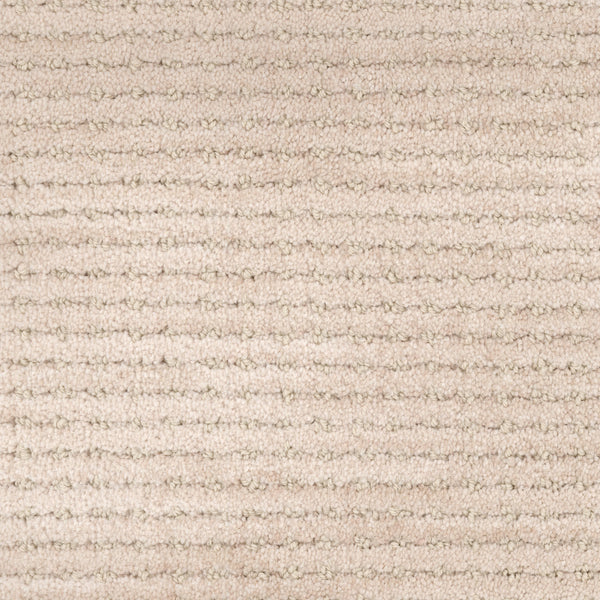 Close-up of the Imagine Pet Friendly Carpet in beige, featuring a uniform horizontal striped texture and soft, raised fibers. The neutral tone adds warmth and cozy appeal, while its handmade look enhances any space.