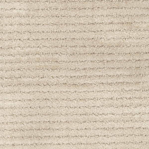 Close-up view of Imagine Pet Friendly Carpet in beige wool, featuring horizontal, evenly spaced ridges for a soft, slightly raised pattern that highlights its handmade authenticity.
