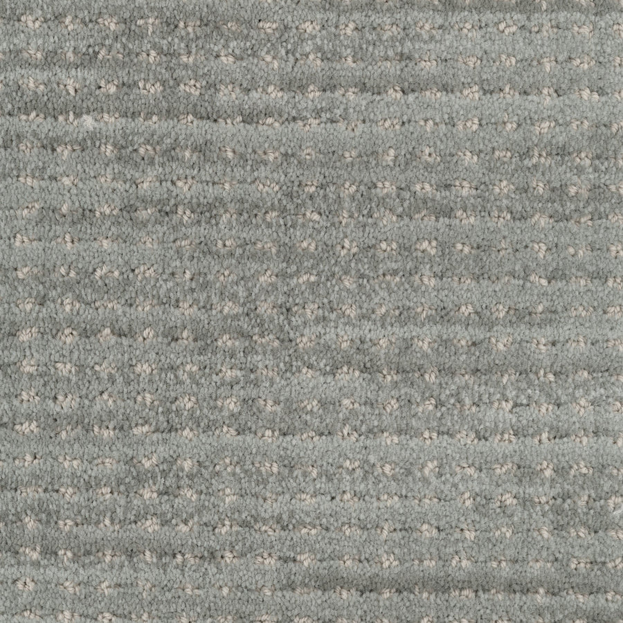 Close-up of Imagine Pet Friendly Carpet in light gray, featuring a soft, plush texture and a subtle grid pattern formed by small, evenly spaced raised dots that highlight its handmade look.