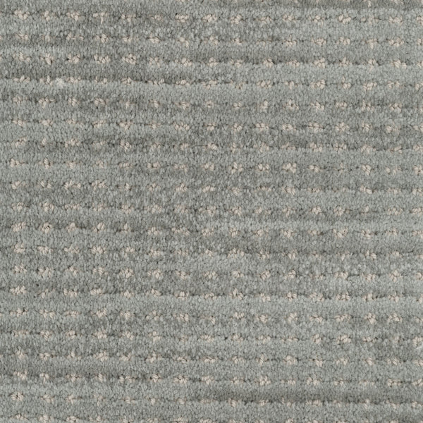 Close-up of Imagine Pet Friendly Carpet in light gray, featuring a soft, plush texture and a subtle grid pattern formed by small, evenly spaced raised dots that highlight its handmade look.
