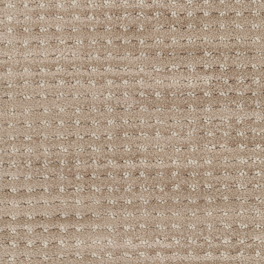 Close-up of Imagine Pet Friendly Carpet in beige, featuring a textured wool surface with a subtle, grid-like loop pattern that showcases its handmade appeal.