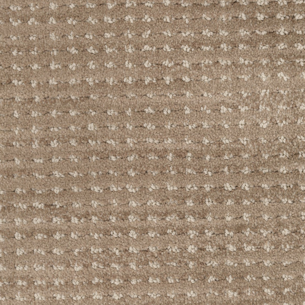 A close-up of Imagine Pet Friendly Carpet reveals a textured beige surface with a grid-like pattern formed by lighter, raised tufts. The soft fibers offer warmth and comfort, showcasing handmade authenticity in every detail.