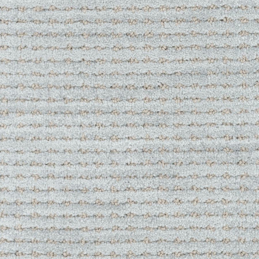 Close-up of Imagine Pet Friendly Carpet in light gray, featuring a subtle horizontal striped pattern with raised rows of fibers. The soft, plush surface and tightly woven loops highlight its quality and handmade appearance.