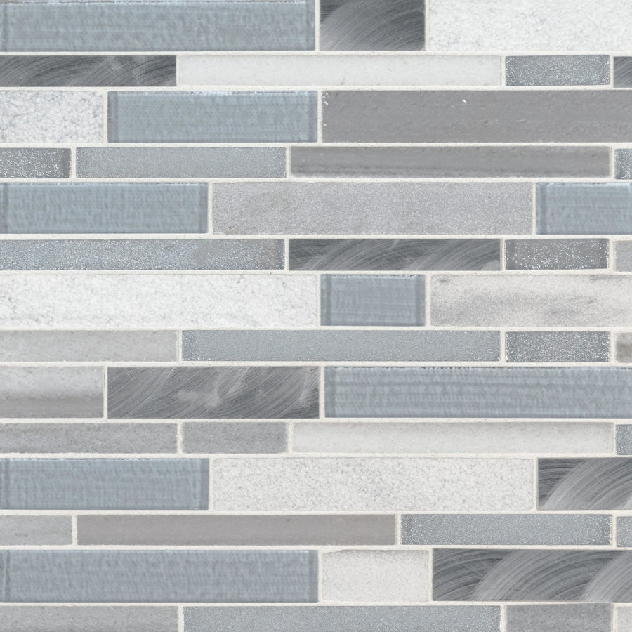 A wall adorned with Interlocking Mosaic Natural Stone tiles in gray and blue, arranged in a staggered pattern. The mix of glossy, matte, and textured finishes creates a striking accent wall.