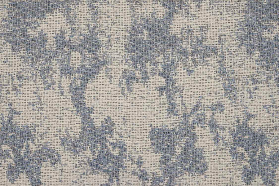 A close-up of the Jacquard Abstract On Trend Carpet shows its blue and off-white textured pattern, featuring a mottled, woven look reminiscent of abstract jacquard designs.