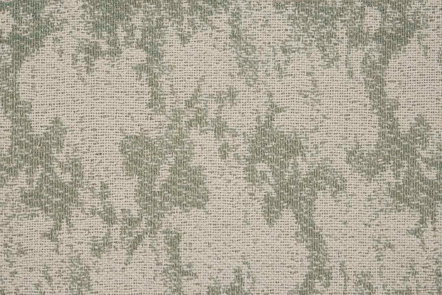 A close-up of the Jacquard Abstract On Trend Carpet features a flatwoven, mottled design in green and beige tones, with green blending irregularly into a beige background for a unique, custom-look rug.
