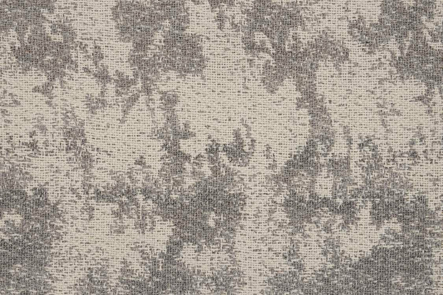 The Jacquard Abstract On Trend Carpet features textured fabric with a mottled gray and beige pattern, resembling watercolor. Its woven surface creates a sophisticated, modern look.