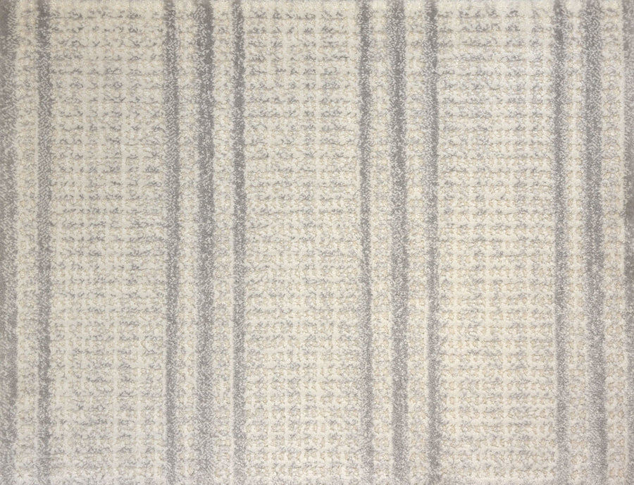 The Jazabella On Trend Carpet is a textured gray and off-white rug with a subtle plaid pattern of varying gray lines. This custom finished carpet is stain resistant, offering lasting style for your space.