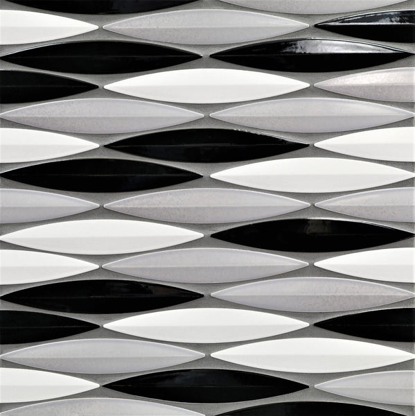 The Ka-Nu Keel 3D Mosaic Tile features elongated, diamond-shaped ceramic tiles in black, white, and gray glazes, arranged in geometric horizontal rows.