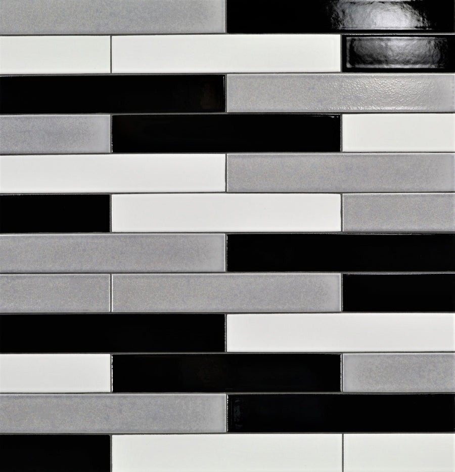 Ka-Nu 1 5/8 x 9 1/2" Plank Ceramic Tiles in black, white, and light gray are installed horizontally in a brick pattern. Their glossy finish highlights the sleek, modern look and geometric appeal.