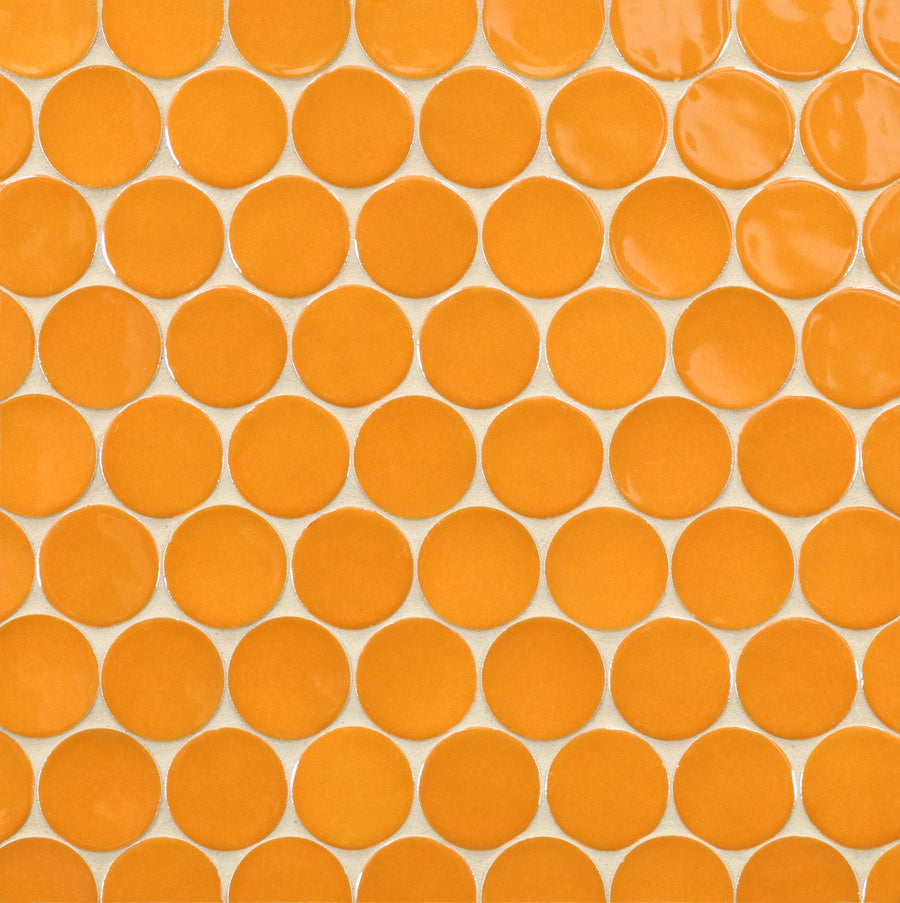 A close-up of a tiled surface featuring Ka-Nu Buoy 2" Pennyround Mosaic Tile—round orange ceramic tiles arranged in a grid with thin white grout lines.