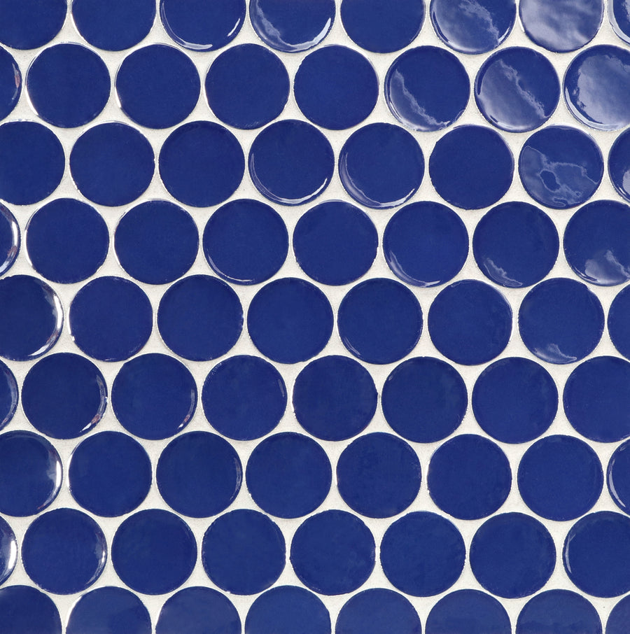 The Ka-Nu Buoy 2" Pennyround Mosaic Tile features glossy round blue ceramic tiles arranged in a precise grid on a white background, highlighting a repeating geometric pattern with expert glazing.