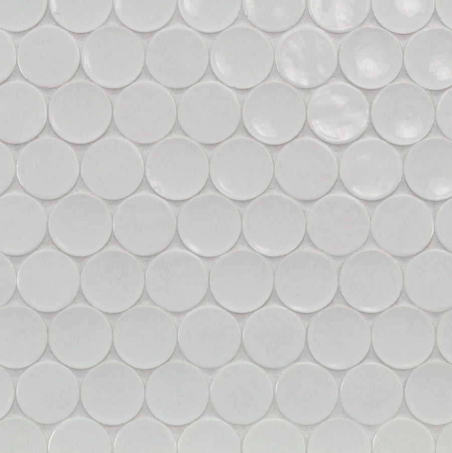 Close-up of Ka-Nu Buoy 2" Pennyround Mosaic Tile, displaying evenly spaced, glossy white ceramic circles with subtle shadows that highlight expert glazing and their distinctive shape.