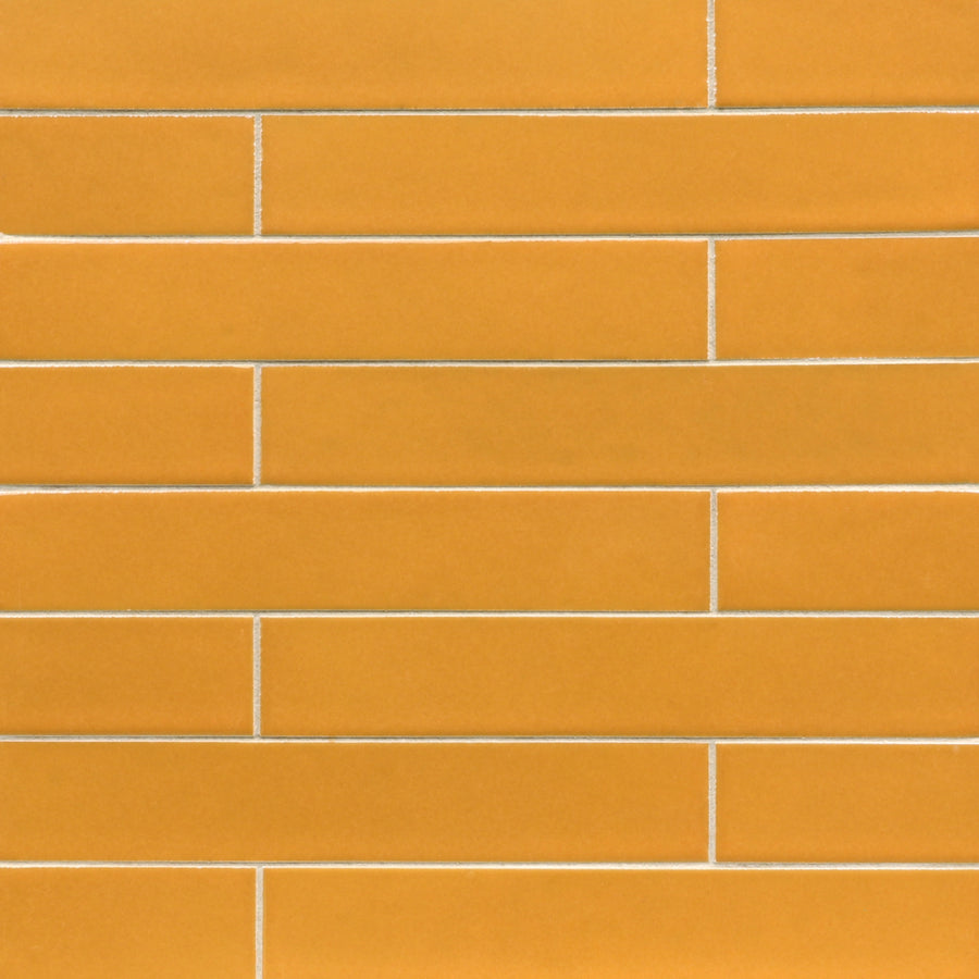 Ka-Nu 1 5/8 x 9 1/2" plank ceramic tiles, set in a horizontal staggered brick pattern with thin white grout, bring vibrant color and style to any space.