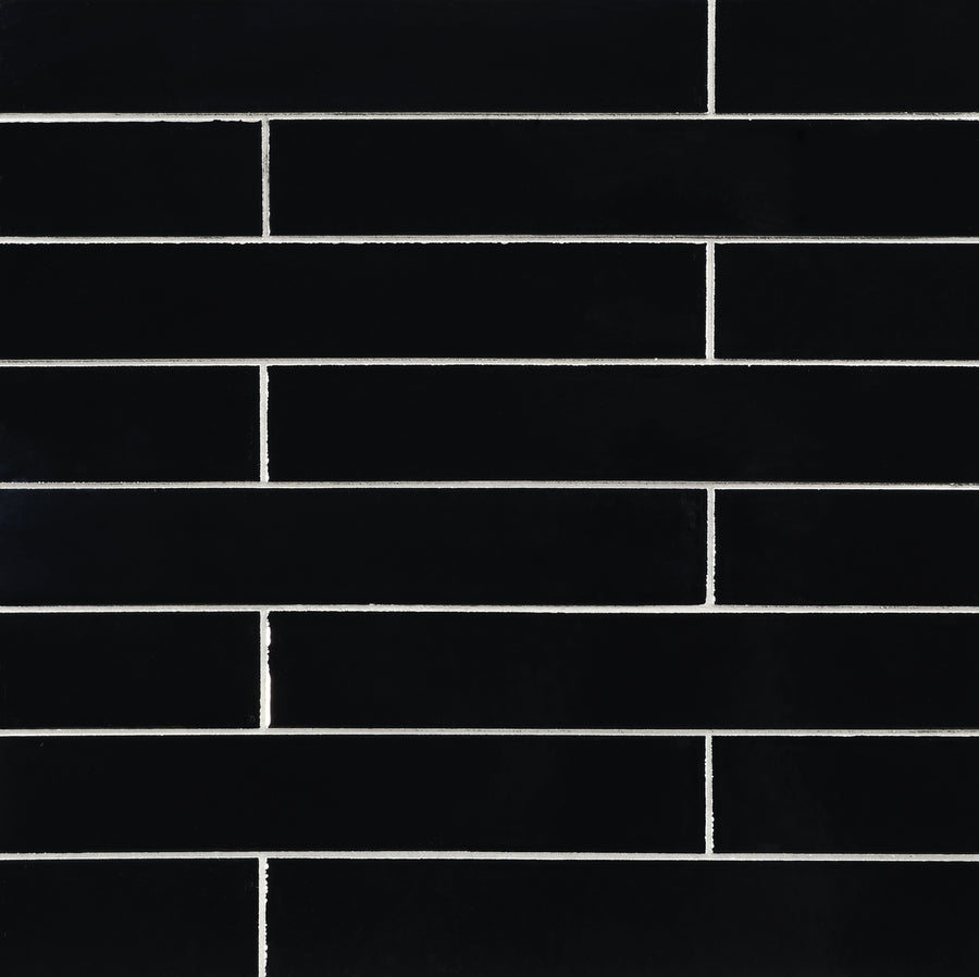 Ka-Nu 1 5/8 x 9 1/2" Plank Ceramic Tile in black is installed in a horizontal brick pattern, with sharp white grout lines accentuating each elongated rectangular tile.