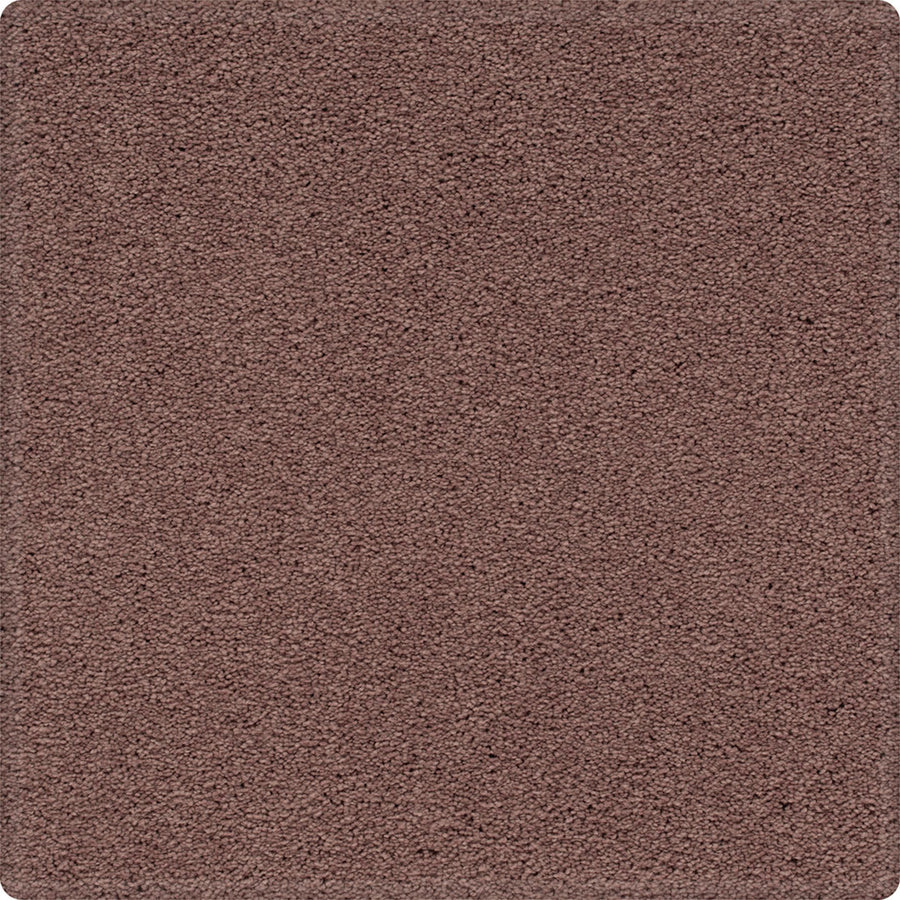 A close-up of the Dynamic Display Family Friendly Carpet shows its dense, textured pile and even surface with rounded corners, highlighting its easy-care durability and inviting feel—an ideal choice for any decorator.