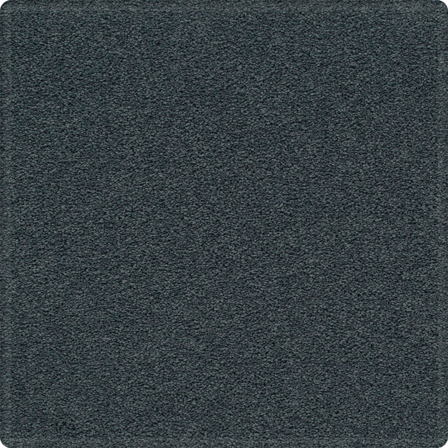 A close-up of the Dynamic Display Family Friendly Carpet shows a square, dark gray tile with a soft, textured surface and slightly rounded corners—an easy-care, durable option ideal for decorators.