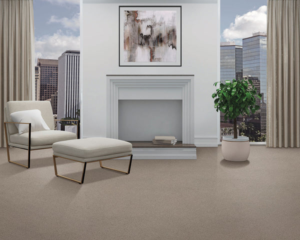 A modern living room features the Dynamic Display Family Friendly Carpet, a white armchair and ottoman, potted plant, abstract art above a white fireplace, large windows, and city views—a decorator’s dream.