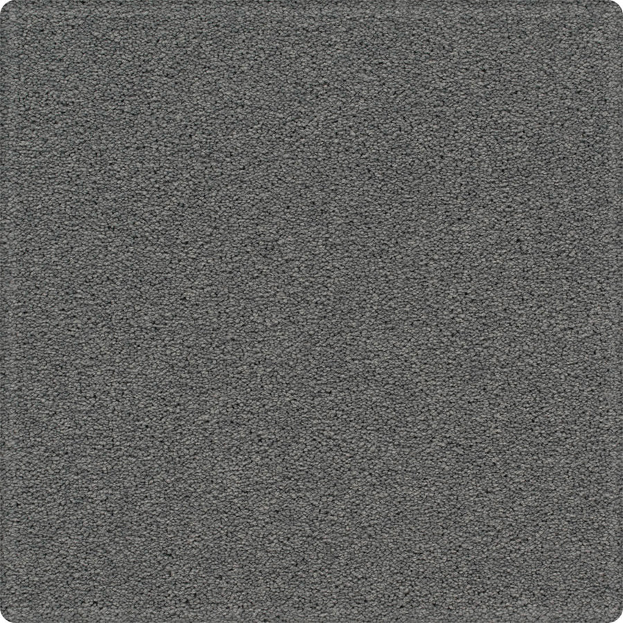 A close-up of the Dynamic Display Family Friendly Carpet reveals a textured gray surface with a uniform pattern and soft, rounded corners—offering easy-care durability that's ideal for any decorator.