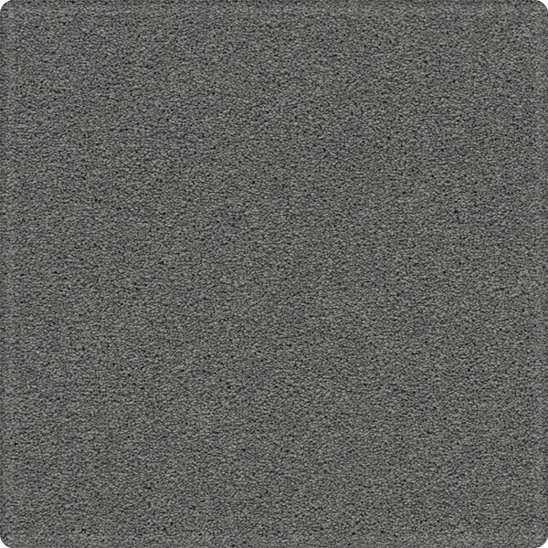 A close-up of the Dynamic Display Family Friendly Carpet reveals a textured gray surface with a uniform pattern and soft, rounded corners—offering easy-care durability that's ideal for any decorator.