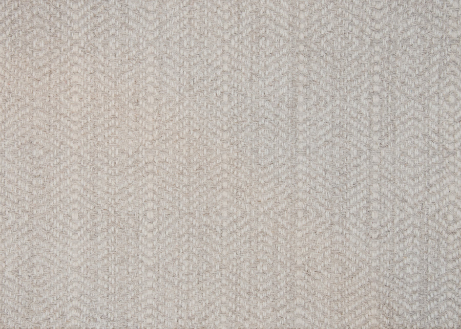 Close-up of Kariba On Trend Wool Carpet in light beige, showcasing a subtle, repeating diamond and chevron pattern. The wool texture looks soft with a slightly coarse feel.