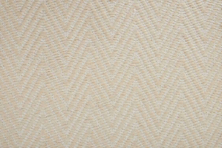 Close-up of the Kauai On Trend Carpet in beige, showcasing a subtle chevron pattern and textured zigzag lines. Its uniform design and neutral tones create a soft, natural look, ideal for relaxed or coastal-inspired interiors.