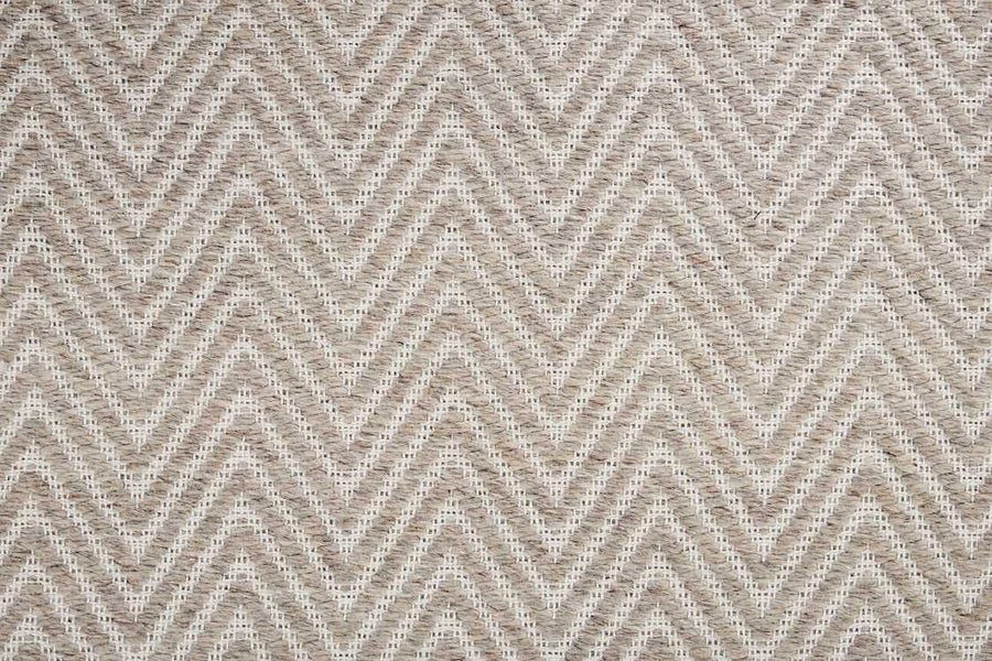Close-up of the Kauai On Trend Carpet, a woven flatweave rug with a repeating chevron pattern in neutral beige and cream tones for a textured, geometric look.