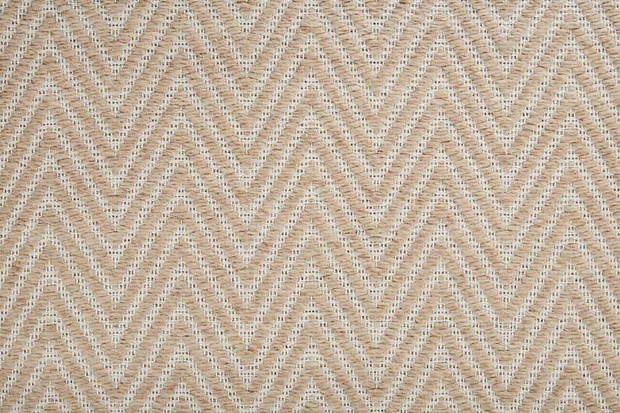 Close-up of the Kauai On Trend Carpet shows its woven flatweave with a repeating chevron pattern in natural beige and cream, creating a textured zigzag design.
