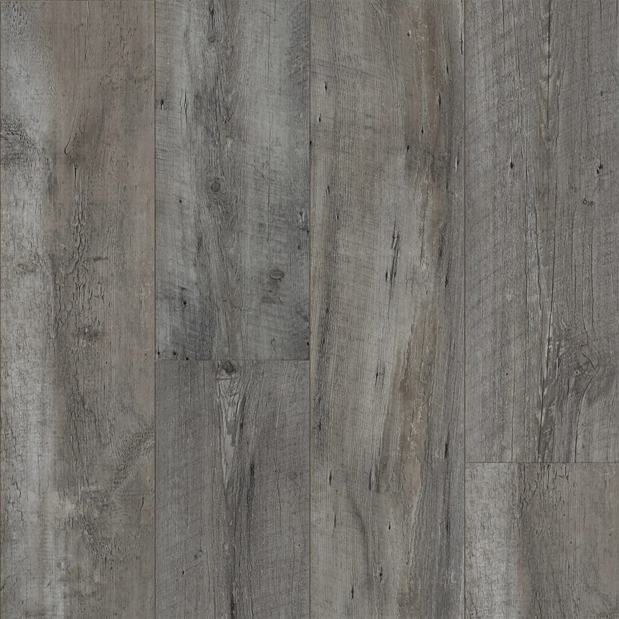Close-up of ArmorStep 7" Vinyl Plank flooring in gray and brown, featuring a weathered, rustic texture with natural wood grain and knots. The waterproof planks are arranged vertically, highlighting varying shades and unique patterns.