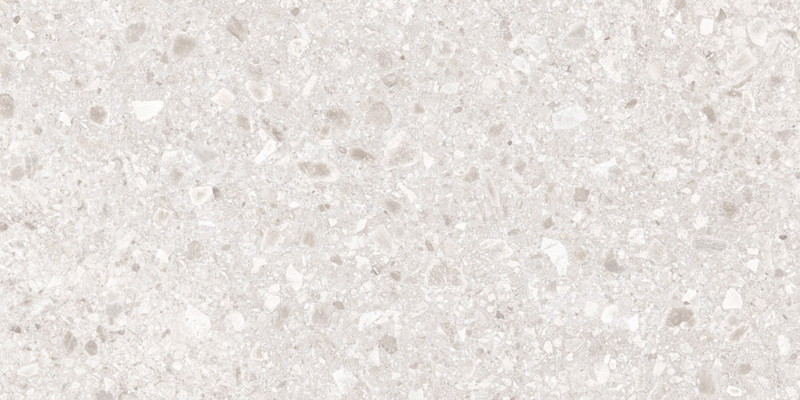 Close-up of the Amalfi 24x48 Porcelain Tile in light beige, featuring small, irregular mineral fragments for a subtle speckled pattern. Its smooth, neutral tone adds a touch of luxury to any interior space.