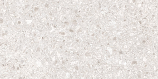 Close-up of the Amalfi 24x48 Porcelain Tile in light beige, featuring small, irregular mineral fragments for a subtle speckled pattern. Its smooth, neutral tone adds a touch of luxury to any interior space.